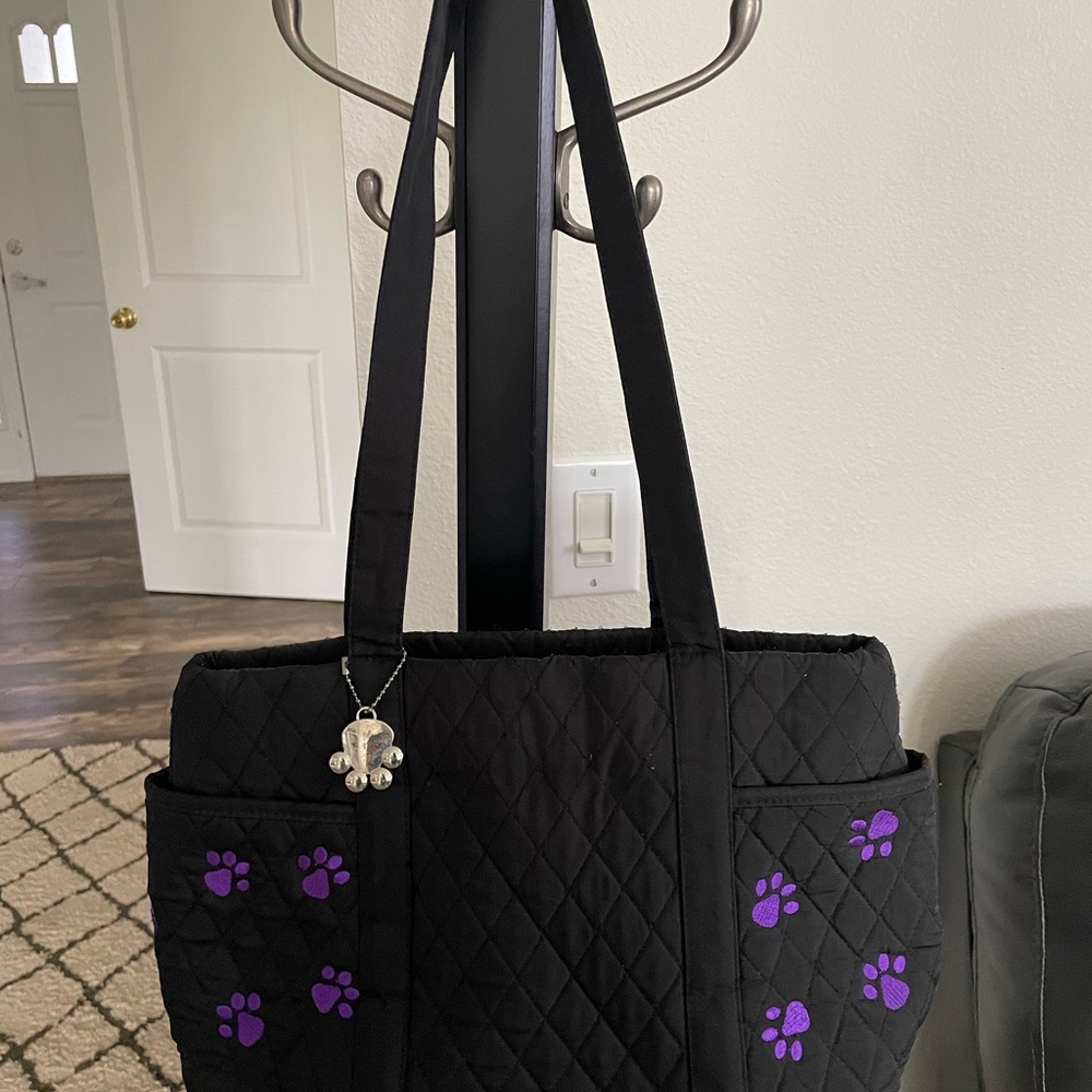 Belvah brand cloth carry bag black with purple paws and charm. Size 15 x 10